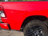 a red pickup truck parked in a parking lot
