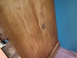 a wooden cabinet with a drawer on top of it