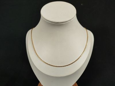 a close up of a necklace on a mannequin with a black background