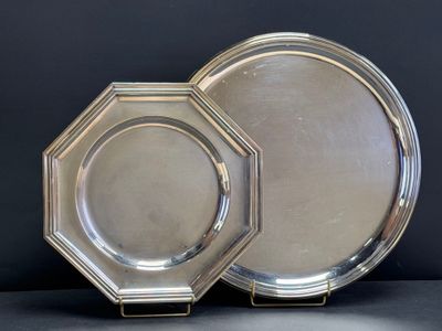 pair of silver plated dishes on stand on black background