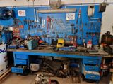 a workbench with many tools on it in a garage