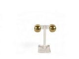 a close up of a pair of gold earrings on a stand