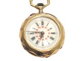 a gold pocket watch with roman numerals on it