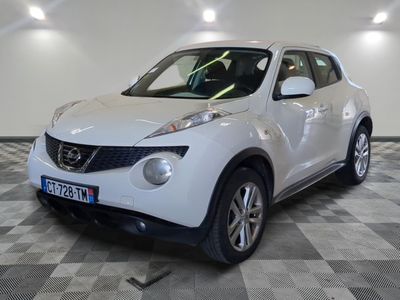 the white nissan juke suv is parked in a large room