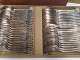a lot of silverware in a box on a table