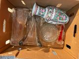 a cardboard box with a bunch of glass items inside of it