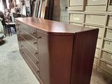 a dresser in the middle of a room with a lot of drawers