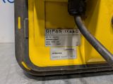 a close up of a yellow machine with a black hose