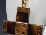 a necklace with a cross made of tortoises on a mannequin