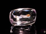 an image of a clear crystal stone on a black surface