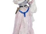 a figurine of a woman in a pink dress holding a bird