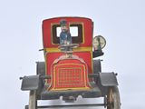 a small red toy car with a man in the driver ' s seat