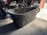 a black bathtub sitting in the middle of a garage