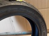 a close up of a tire on a cardboard box with a yellow sticker on it