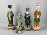 five figurines of asian figures are lined up in a row