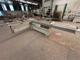 a machine that is cutting wood in a factory
