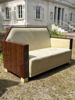 a couch that is sitting in the grass in front of a house