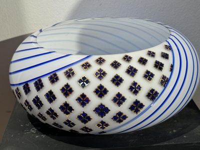 a white bowl with blue and black designs on it