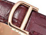 the belt is made of leather and has a gold buckle