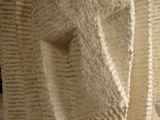 a sculpture of a face made out of white paper