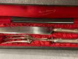a knife, fork and knife set in a red box