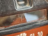 a close up of a parking meter with a sticker on it