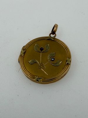 an image of a gold locke with a blue stone in the center