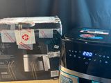 a close up of a coffee maker on a table next to a box of coffee