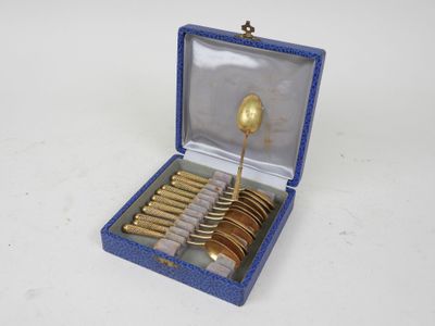 a blue box with gold spoons and spoons in it