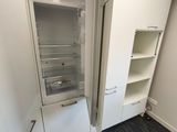an open refrigerator in the corner of a room