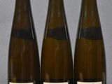 three bottles of wine sitting on top of a table next to each other