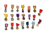 a lot of medals and medals on display on a white surface