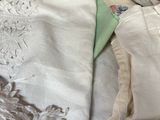 many different types of clothing laid out on a bed