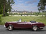 a red convertible car that is parked on the side of the road