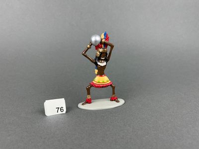 a small figurine of a woman with a ball in her hand