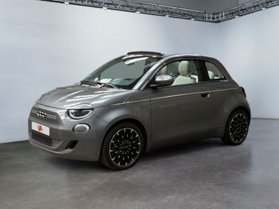 the small car is parked in a large room with white walls