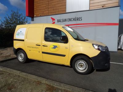 une petite camionnette jaune garée devant un immeuble