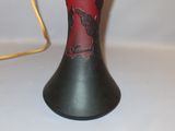 a black vase with a red and black design on it