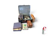 a suitcase full of books sitting on a white surface
