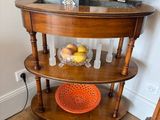 a wooden table with a bowl of fruit and a potted plant on it
