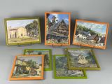 several paintings of a farm scene are displayed on a table