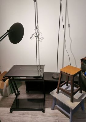 a desk with a chair and a lamp in a room