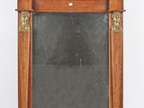 an old wooden mirror with a black glass in the middle of it