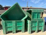 three green bins sitting next to each other on the ground