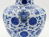 a blue and white vase with a dragon on it
