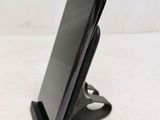 a cell phone that is on a stand on a table