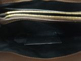 the inside of a brown purse with a zipper on it