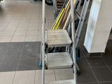 a ladder that is sitting in a room next to a wall