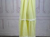 an image of a yellow dress on a mannequin stand