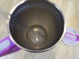 a blender with a spoon in it sitting on a table
